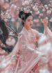 tieutuemjpro112_The_background_is_a_peach_blossom_forest_and_th_6521906c-004e-41f0-9d4c-bb2cde1d9571